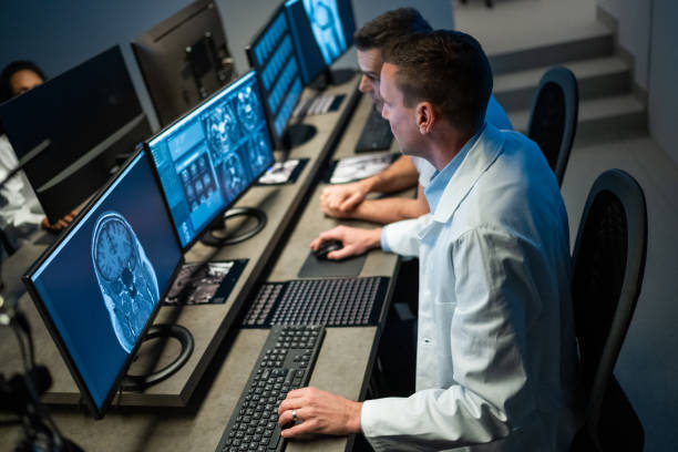istock Colleagues in MRI control room analyzing medical scans on computer. 1320844615