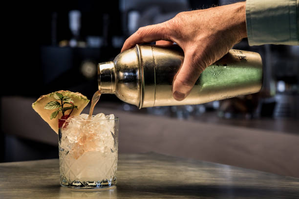 preparing tasty cocktail, using cocktail shaker. - action alcohol alcoholism bar imagens e fotografias de stock