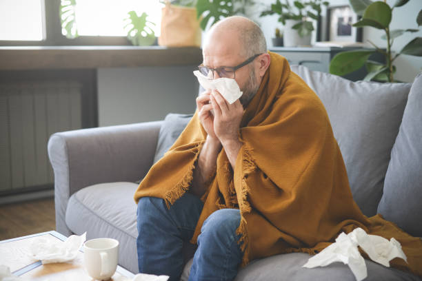 istock sick man sitting on a sofa in the room 1320845369