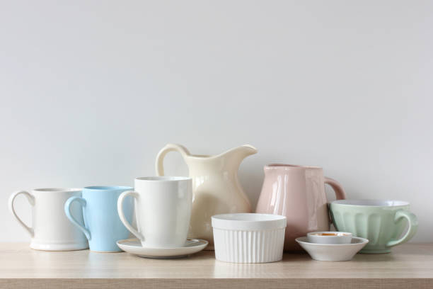 istock light-colored jugs and mugs on the shelf, kitchen background. 1320847666