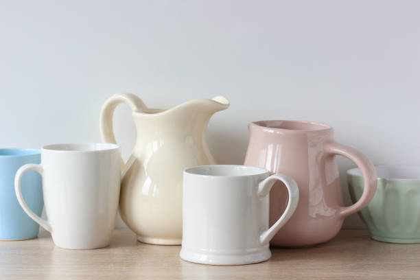istock light-colored jugs and mugs on the shelf. 1320847716