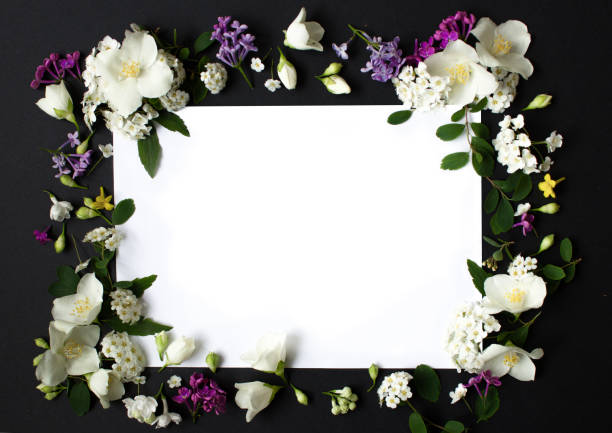 istock Floral frame made of different spring flowers on black background. Flawers flat lay. Space for text 1320847995