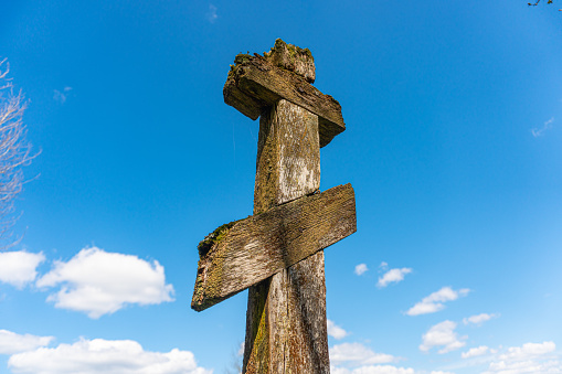 Vintage wooden christian orthodox cross on blue sky background. High quality photo