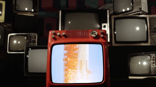 Historical Color Footage of the Apollo 11 Rocket Launch in an Old Retro TV among Many Vintage Televisions. Slow Motion. Zoom In. Elements of this Video Furnished by NASA.