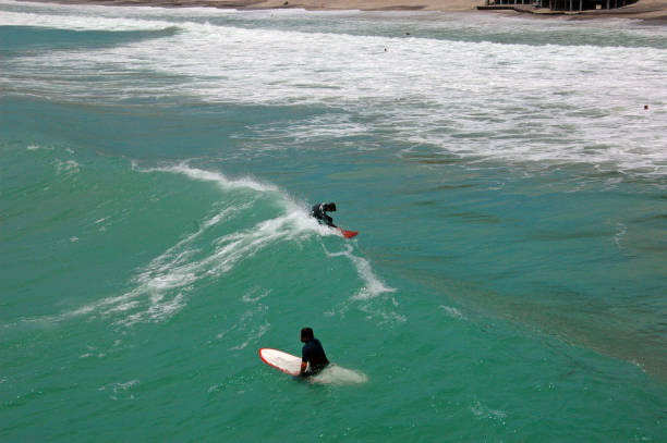 istock Surfers catching a wave-Dana Point California 1320853872