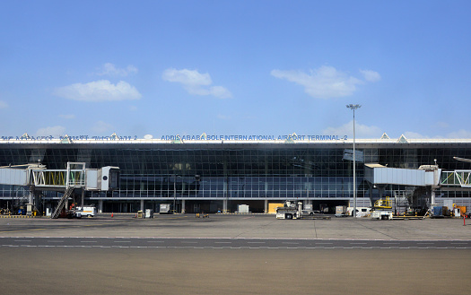 Addis Ababa, Ethiopia: air-side view of Terminal 2 with passenger boarding bridges at Addis Ababa Bole International Airport -  sign in Amharic  and English.