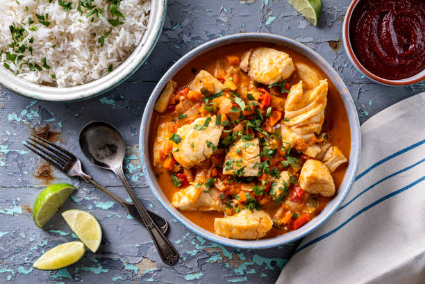 Brazilian Fish Stew Moqueca Delicious Brazilian fish stew moqueca with tomato, lime, red pepper, coconut milk and cilantro. main course stock pictures, royalty-free photos & images