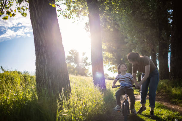istock Mom teaching her son biking 1320859437