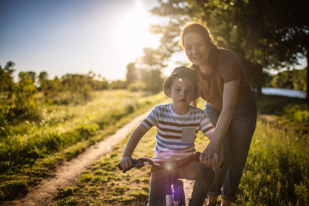 istock Mom teaching her son biking 1320859443