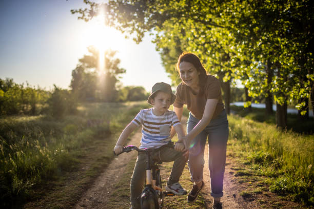 istock Mom teaching her son biking 1320859539