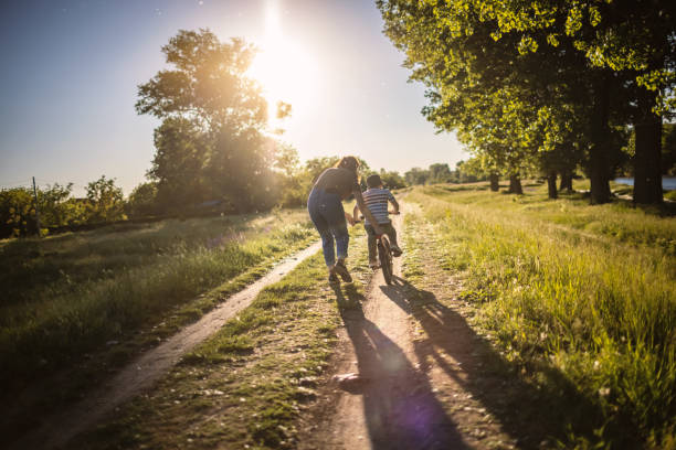 istock Mom teaching her son biking 1320859551