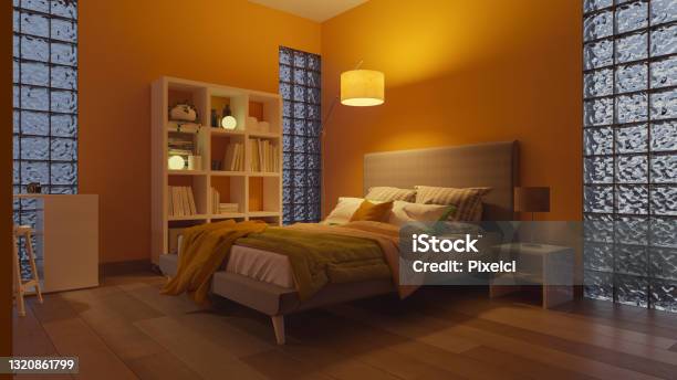 The Bookshelf And The Bed Inside A Softly Illuminated Bedroom With Glass Blocks Stock Photo - Download Image Now