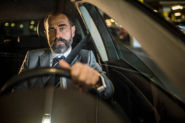 istock Businessman driving a car. 1320867601