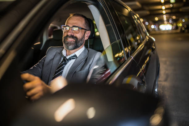 istock Businessman driving a car. 1320867611