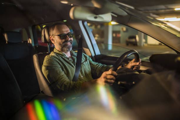 istock Happy casual man driving a car. 1320867615