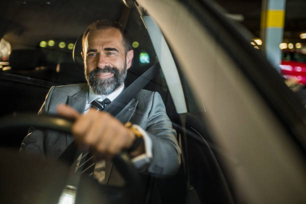 istock Businessman driving a car. 1320868258