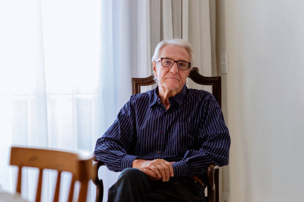 istock Mister sitting on chair looking at camera 1320868480