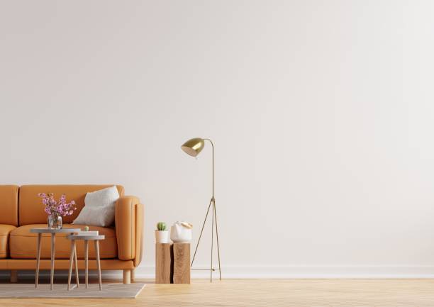 istock Living room interior wall mockup in warm tones with leather sofa on white wall background. 1320870116