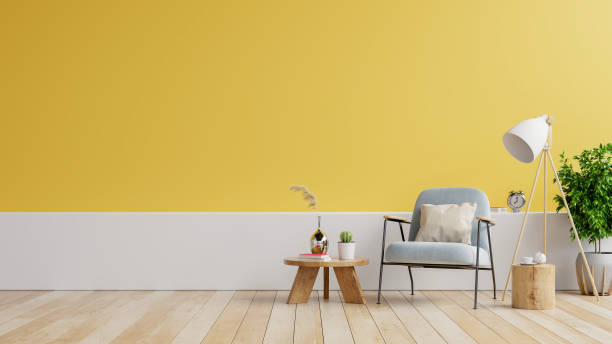 istock Modern minimalist interior with an armchair on empty white,yellow wall background. 1320870124