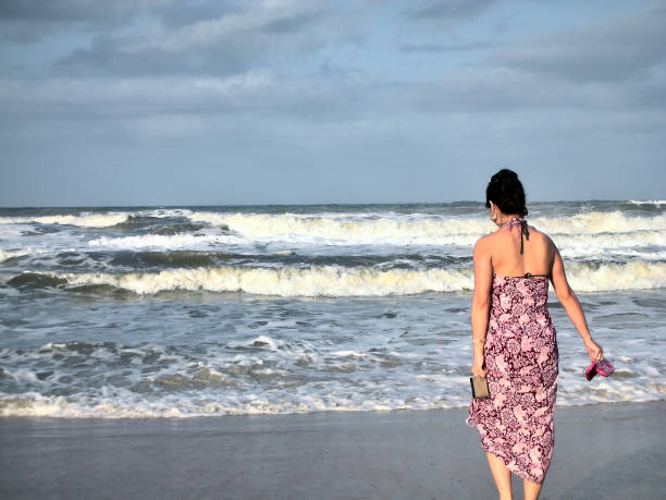 istock Woman on Beach with ocean 1320870589
