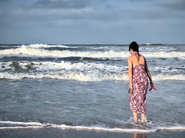 istock Woman on Beach with ocean 1320870590