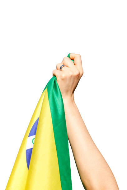 istock Man holding Brazil flag isolated on white background. 1320873097