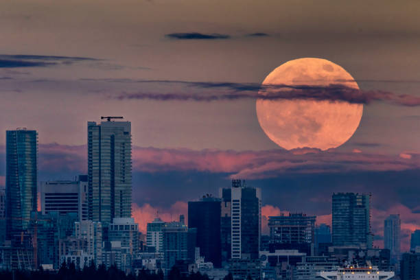 Super Flower Moonrise at sunset over Vancouver skyline Super Flower Moonrise at sunset over Vancouver skyline west vancouver stock pictures, royalty-free photos & images