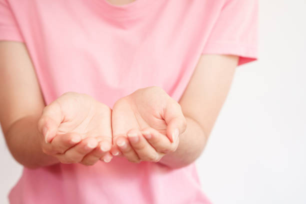 istock Close up of womans hands as if holding something. Selective focus. 1320876529