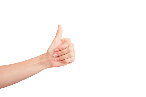 A woman's hand with a thumbs up isolate on a white background. Clipping path.