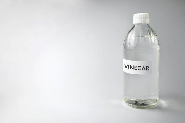 A Bottle Of Vinegar Against Gray Background stock photo