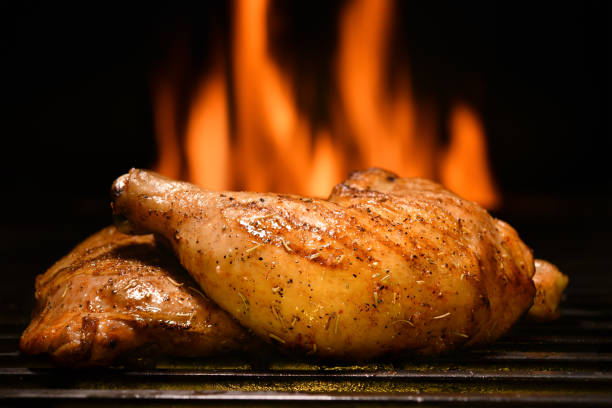 istock Grilled chicken thighs on the flaming grill 1320879772