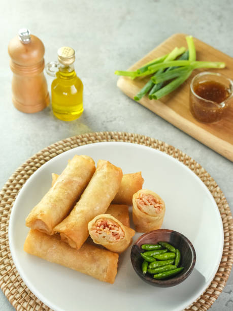 istock Lumpia or lunpia, a traditional snack from Semarang, Central Java, Indonesia. Traditional Spring rolls food containing eggs, and chicken or shrimp. 1320879952
