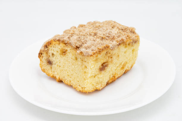 Delicious slices of homemade cake with nuts served on a white plate, showcasing a perfect treat for snacks.