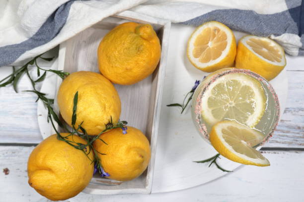 istock Lemons in a tray with Lemonade. 1320887977