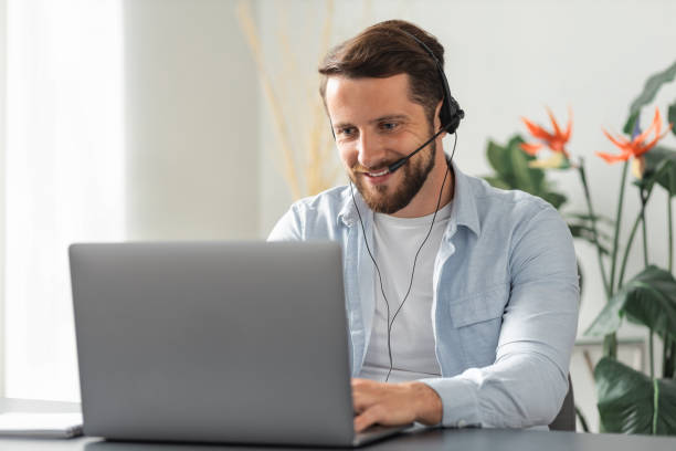 istock Happy caucasian man customer service worker communicates with the client using a headset with a microphone, call center employee, advises clients online, support operator 1320889457