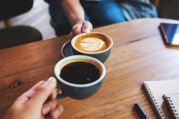 istock A man and a woman clinking coffee mugs in cafe 1320889675