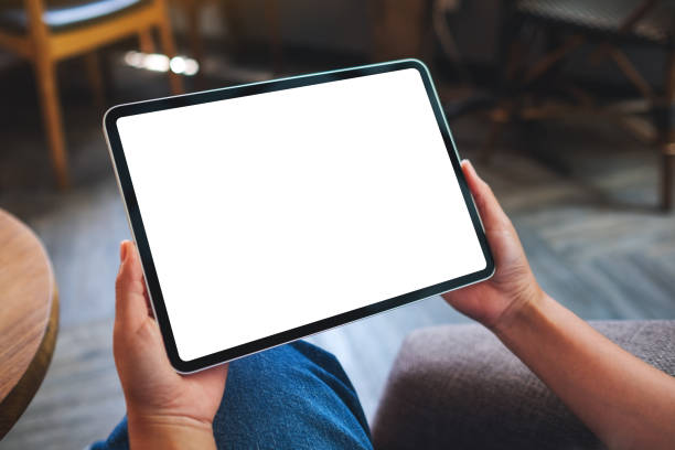 istock a woman holding digital tablet with blank white desktop screen 1320889677