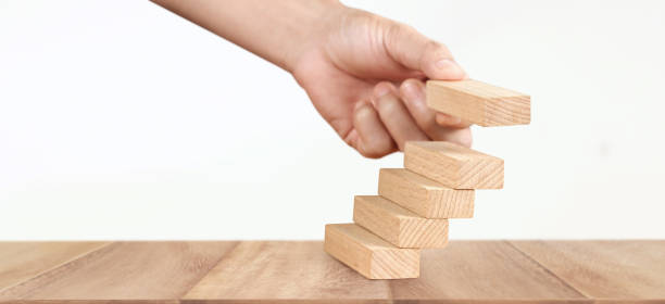 istock Hand arranging wood block stacking as step stair, Business concept growth success process 1320890414