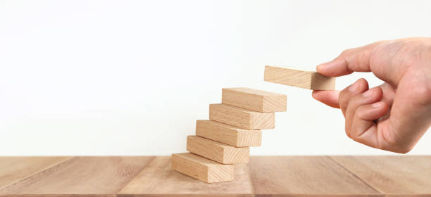 istock Hand arranging wood block stacking as step stair, Business concept growth success process 1320890417