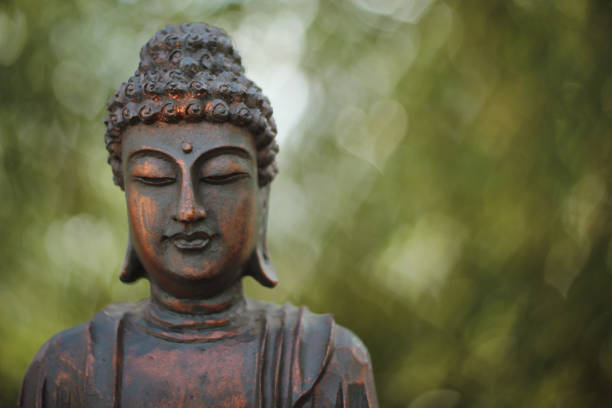 istock Buddha Statue in Outdoor Garden With Blurred Background 1320893001