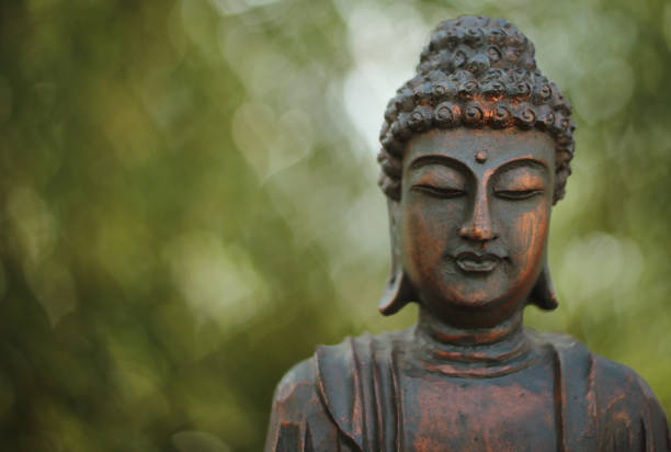 istock Buddha Statue in Outdoor Garden With Blurred Background 1320893008
