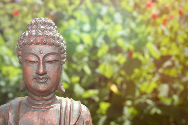 istock Buddha Statue in Outdoor Garden With Blurred Background 1320893195