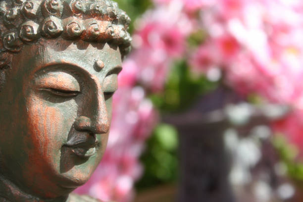 istock Buddha Statue in Outdoor Garden With Blurred Background 1320893277