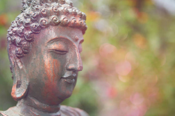 istock Buddha Statue in Outdoor Garden With Blurred Background 1320893281