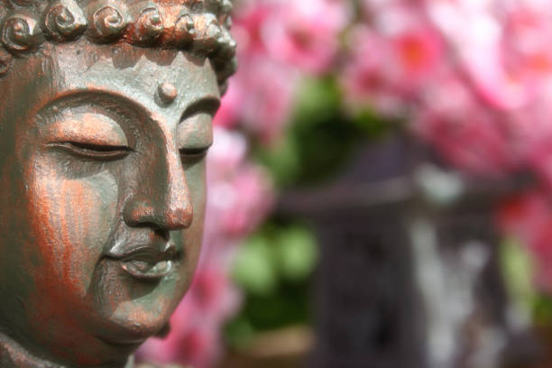 istock Buddha Statue in Outdoor Garden With Blurred Background 1320893282
