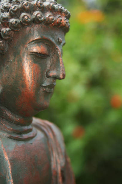 istock Buddha Statue in Outdoor Garden With Blurred Background 1320893302