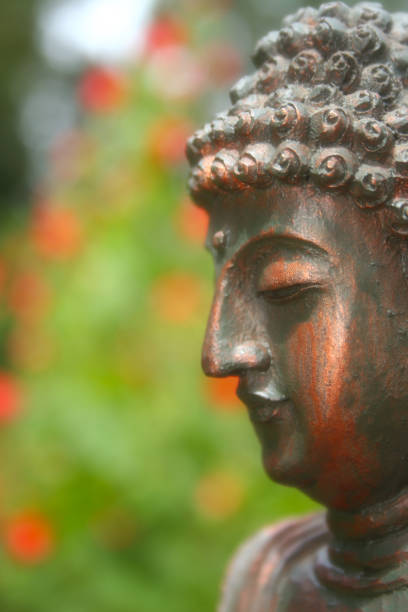 istock Buddha Statue in Outdoor Garden With Blurred Background 1320893322