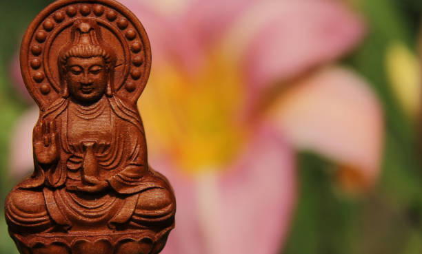 istock Buddha Statue in Outdoor Garden With Blurred Background 1320893368