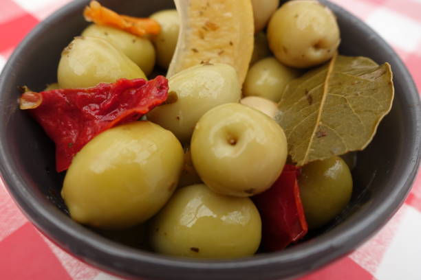 green olives in brine and aromatics bay leaf red pepper candied lemon - bay leaf healthy eating food and drink red imagens e fotografias de stock