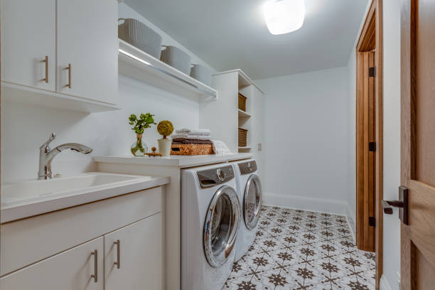Patterned tile flooring in big laundry room New washer and dryer in utility room utility room stock pictures, royalty-free photos & images